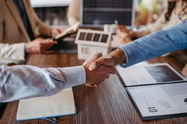 Close up of businesmans shaking hands in the office.