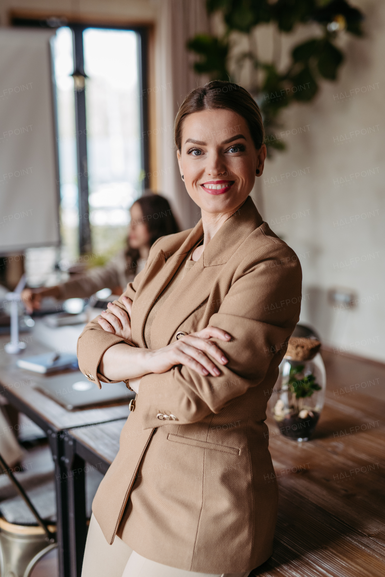 Portrait of confident businesswoman during team meeting. Powerful female business leader, ceo.