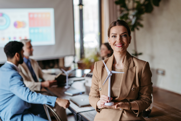 Portrait of confident businesswoman during team meeting. Powerful female business leader, ceo.