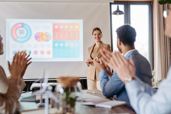 Female business leader giving a presentation about renewable energy. Applause after the presentation. green, energy. Business using green energy.