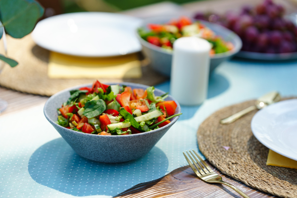 Delicious fresh vegetable salad. Preparing meals, refreshments for garden party. Outdoor grill or BBQ party.