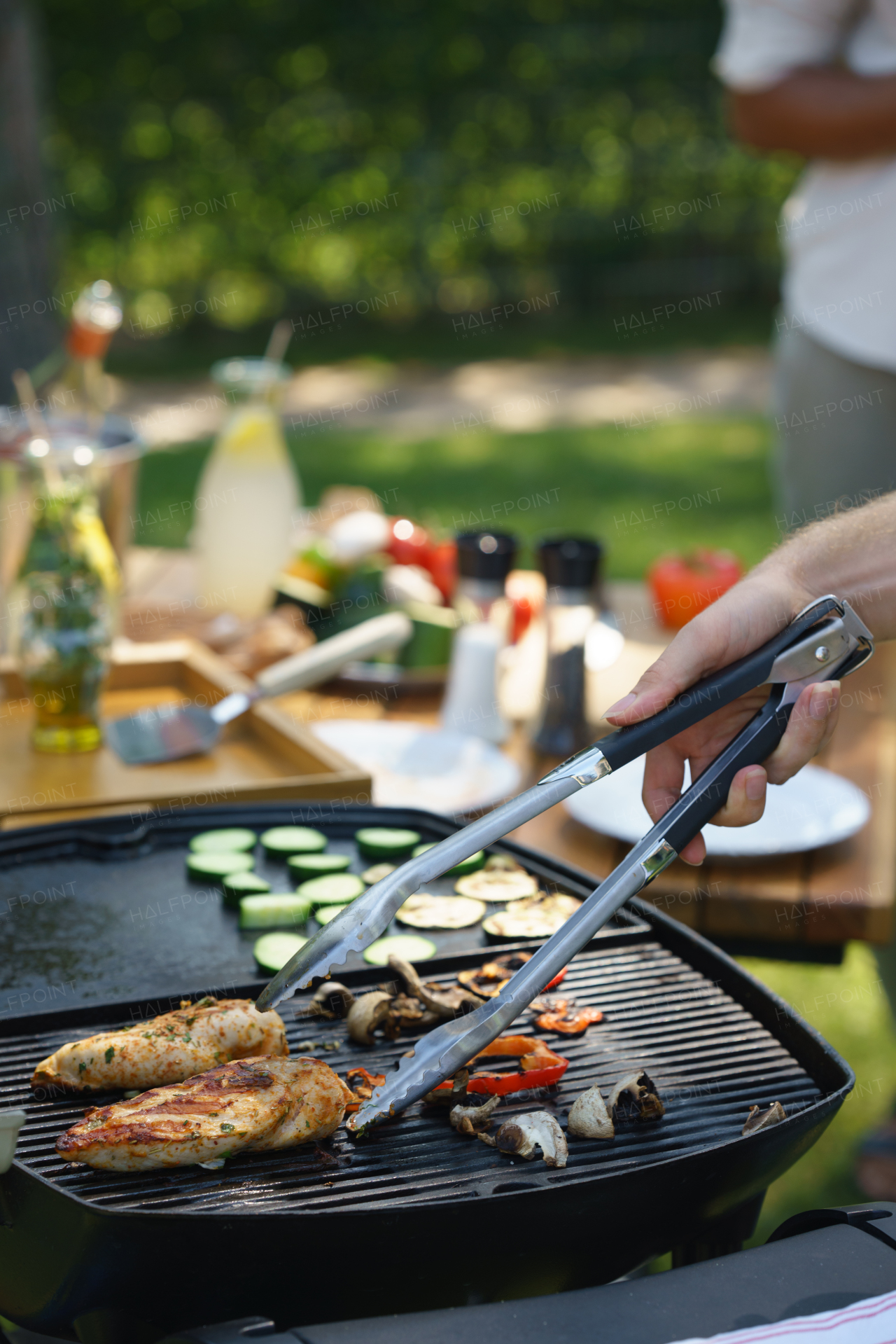 Meat and vegetables grilling on an outdoor grill. Outdoor grill or BBQ party in the garden.