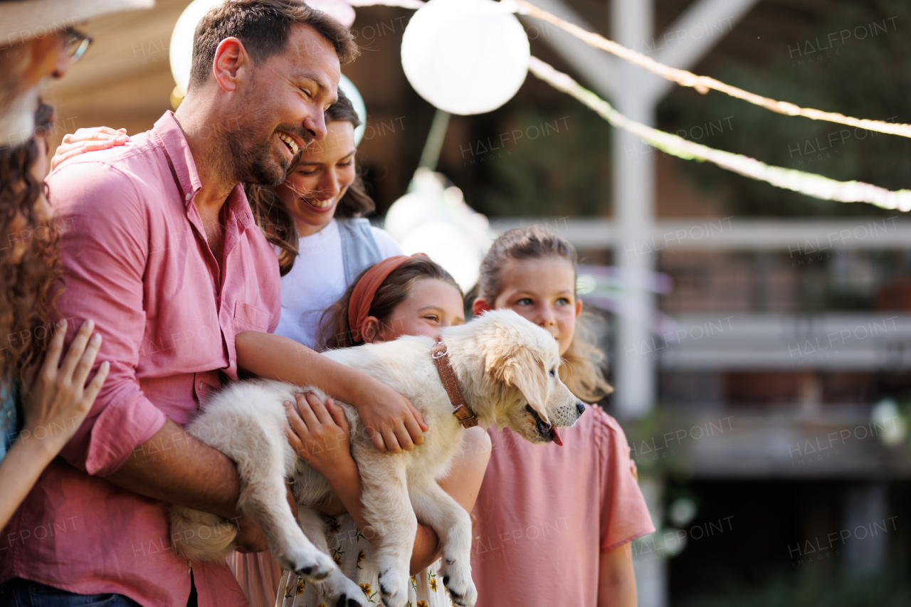 Garden birthday party with surprise. Family prepared a birthday surprise, puppy as a birthday gift.