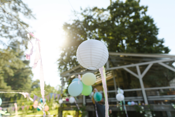 Close up shot of a paper lantern at a garden party. Ideas for simple elegant decorations for outdoor BBQ, garden, or grill parties.