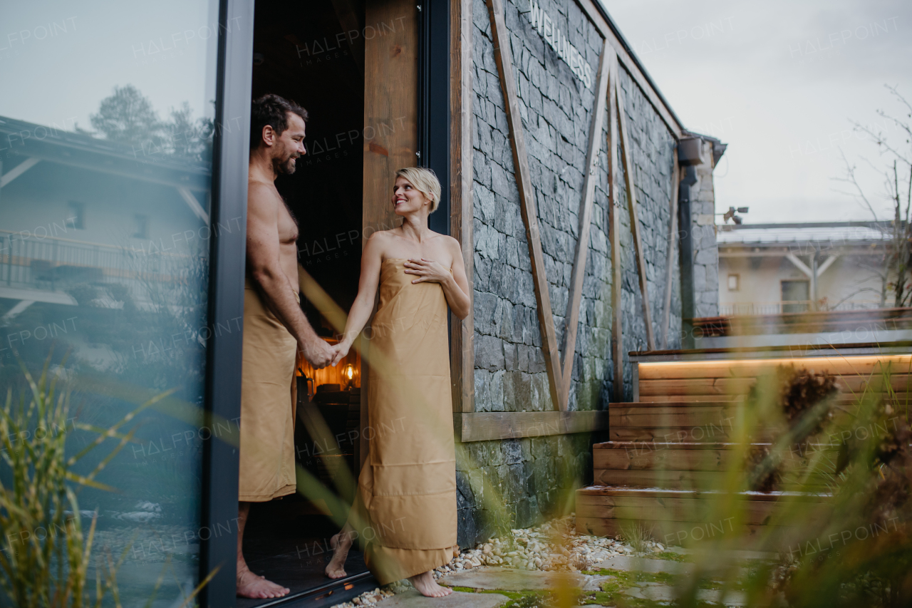 Beautiful couple standing in hotel wellness, enjoying romantic weekend in the spa. Concept of Valentine's Day.