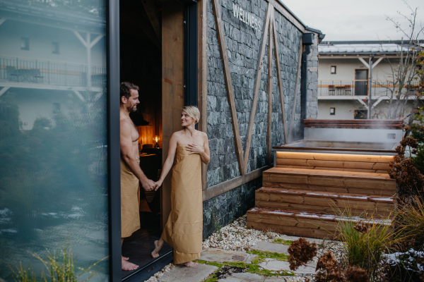 Beautiful couple standing in hotel wellness, enjoying romantic weekend in the spa. Concept of Valentine's Day.