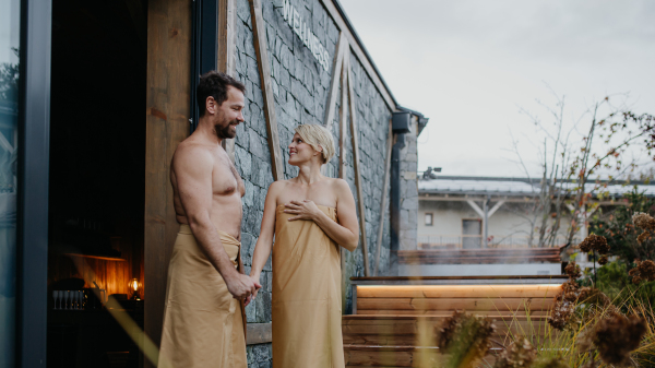 Beautiful couple standing in hotel wellness, enjoying romantic weekend in the spa. Concept of Valentine's Day.