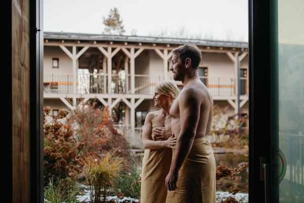 Beautiful couple standing in hotel wellness, enjoying romantic weekend in the spa. Concept of Valentine's Day.