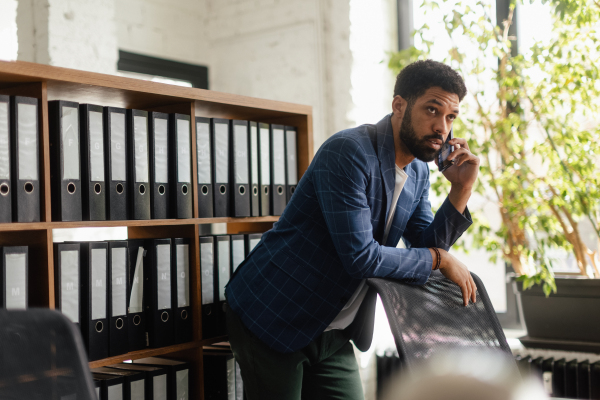 Multiracial man having call in the office.