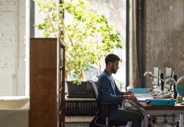 Young man sitting in an office and working.