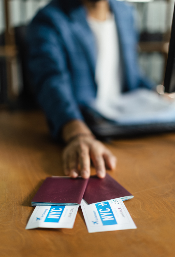 Close up of man, travel agency worker holding plane tickets.