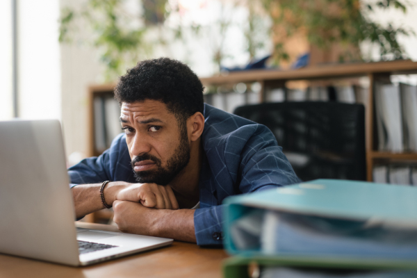 Multiracial man working on computer in the office.