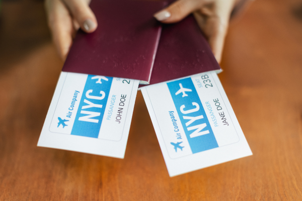 Close up of womans hands holding plane tickets, concept of travel.