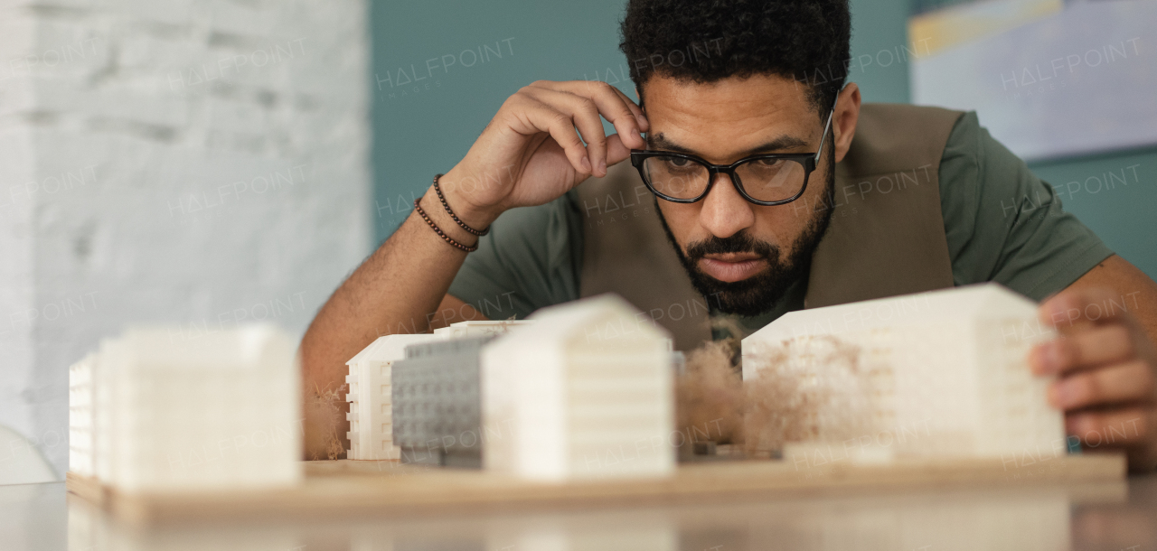 Young multiracial architect designing building in his office.