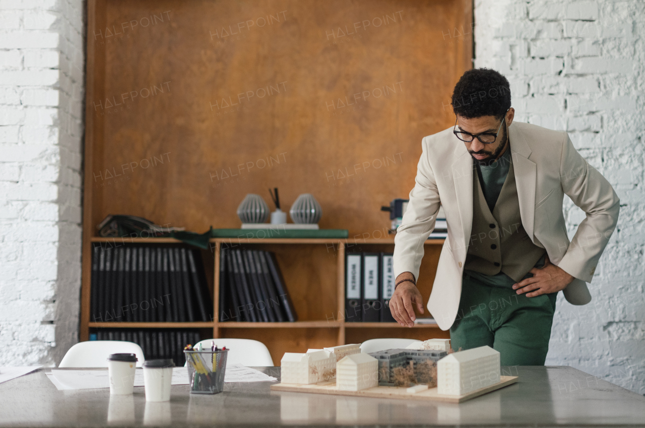 Young multiracial architect designing building in his office.