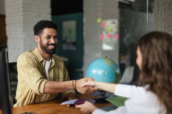 Young woman at job interview in office, shaking hands.