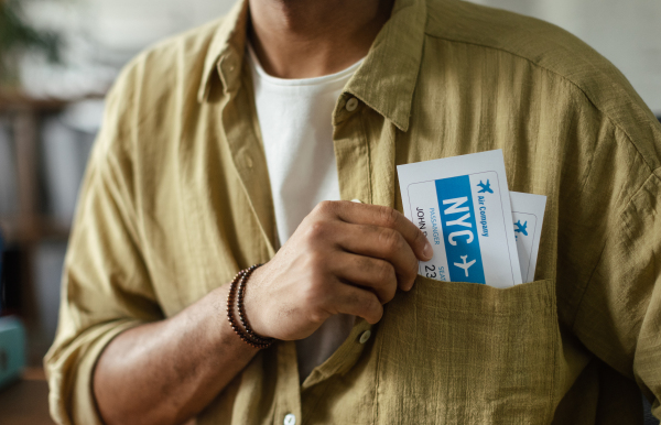 Close up of man, travel agency worker holding plane tickets.