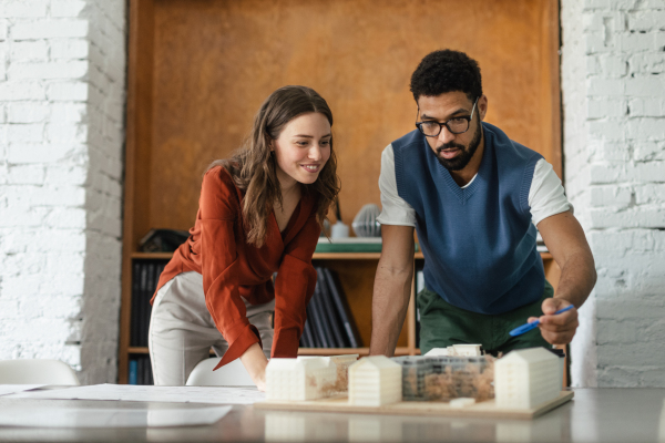 Young colleagues working as architects in the office.