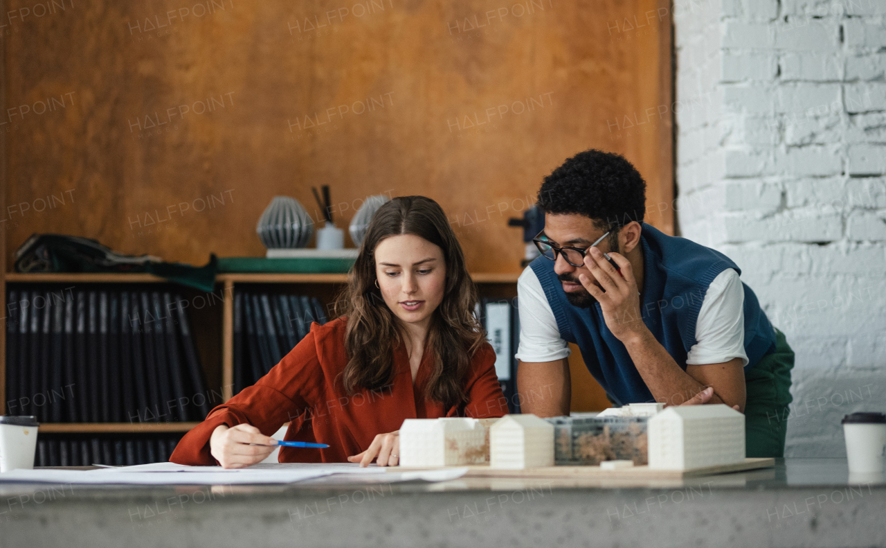 Young colleagues working as architects in the office.