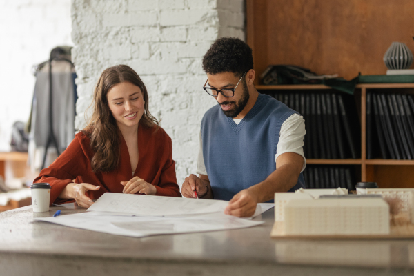 Young colleagues working as architects in the office.