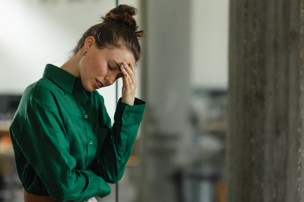 Young sad woman in office, having troubles.