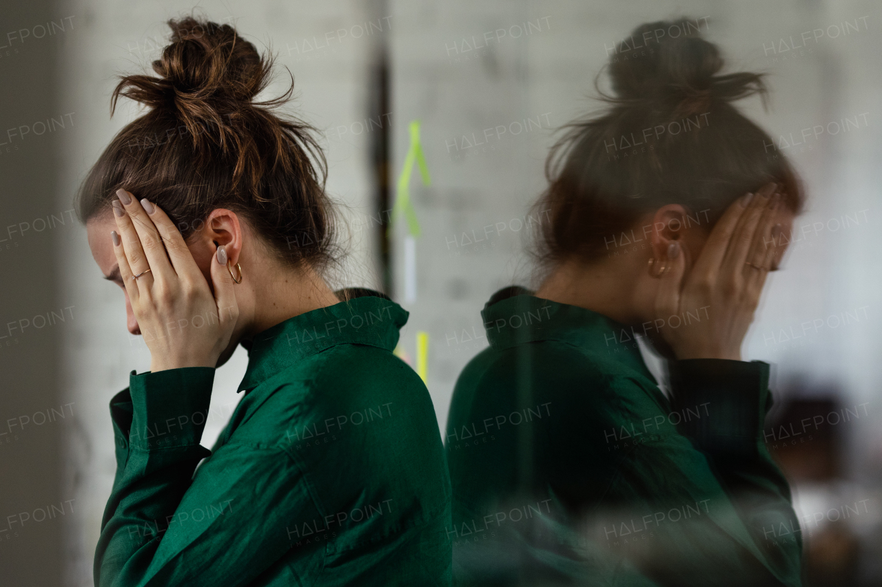 Young sad woman in office, having troubles.