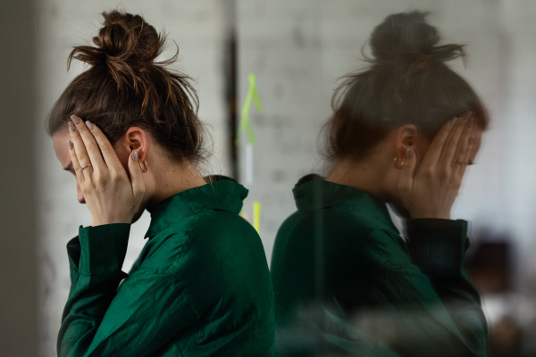 Young sad woman in office, having troubles.