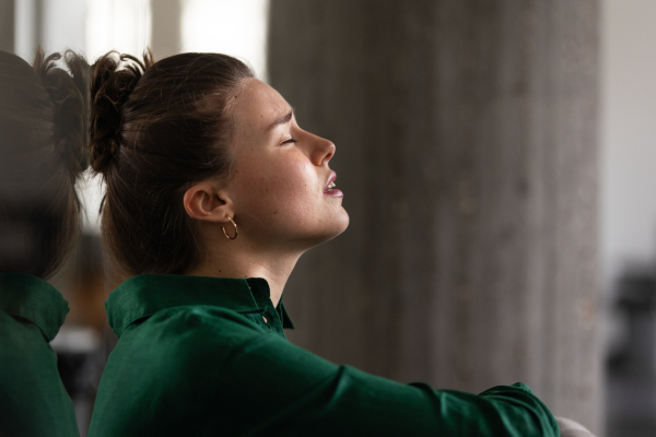 Young exhausted woman in office, having troubles.