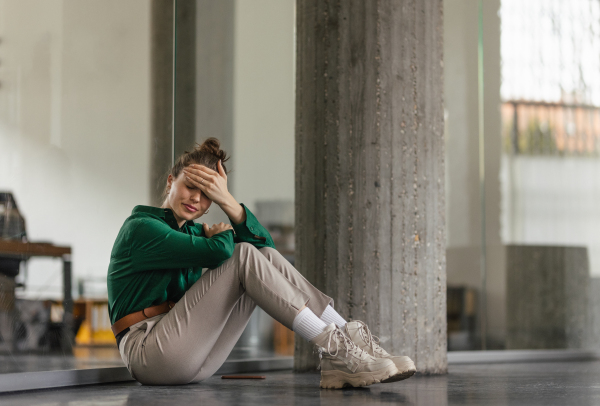 Young sad woman in office, having troubles.