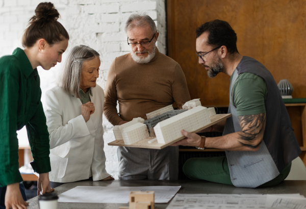 Young architects designing house for senior couple. Buing new house in retirement.