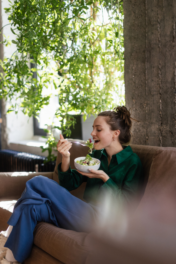 Young woman having lunch in the office.