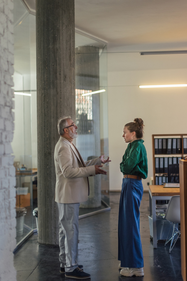 Disappointed boss ceo scolding young office worker, intern. Reprimand, discrimination at work concept