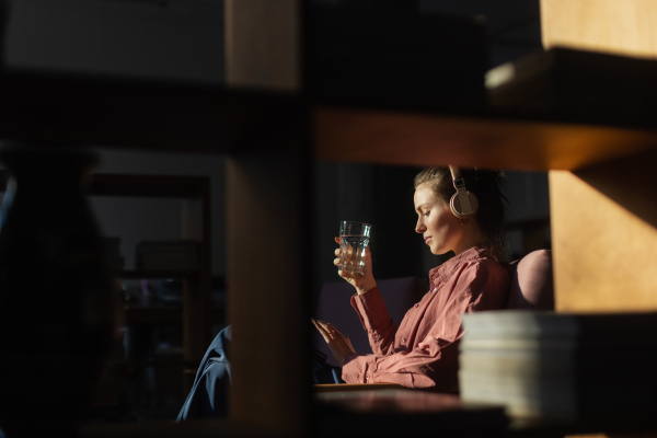 Young woman having a break during work, listening music.