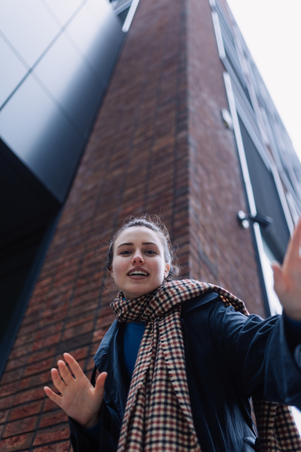 Young woman walking outdoor, in an autumn city.