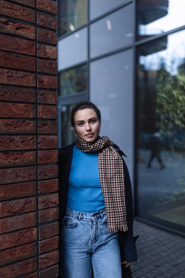 Young woman walking outdoor, in an autumn city.