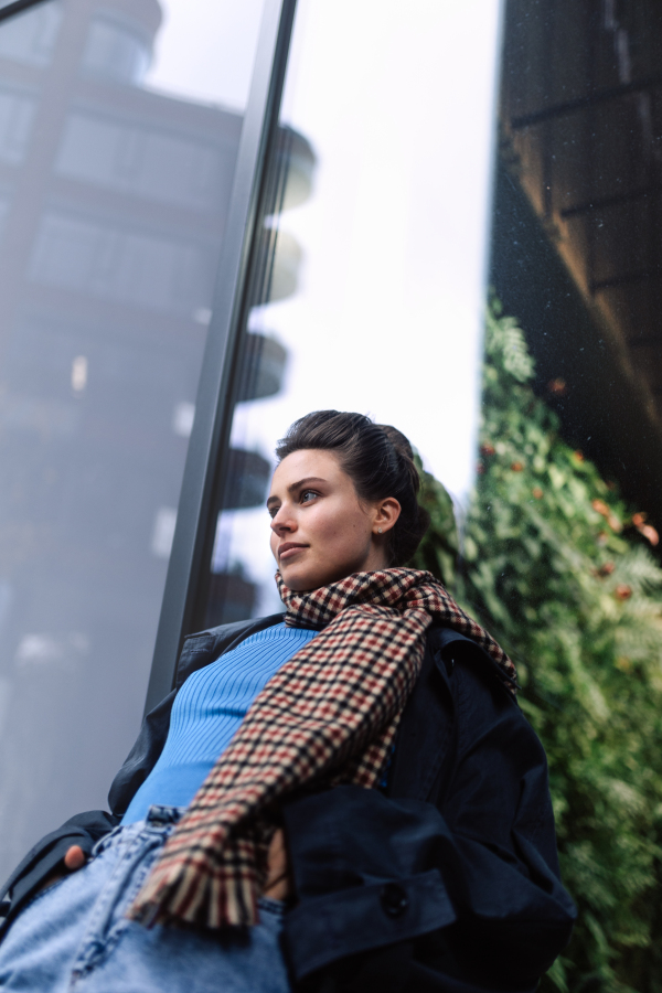 Young woman walking outdoor, in an autumn city.