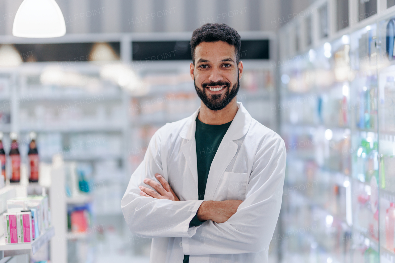 Portrait of young multiracial pharmacist looking at camera, standing in a pharmacy store.