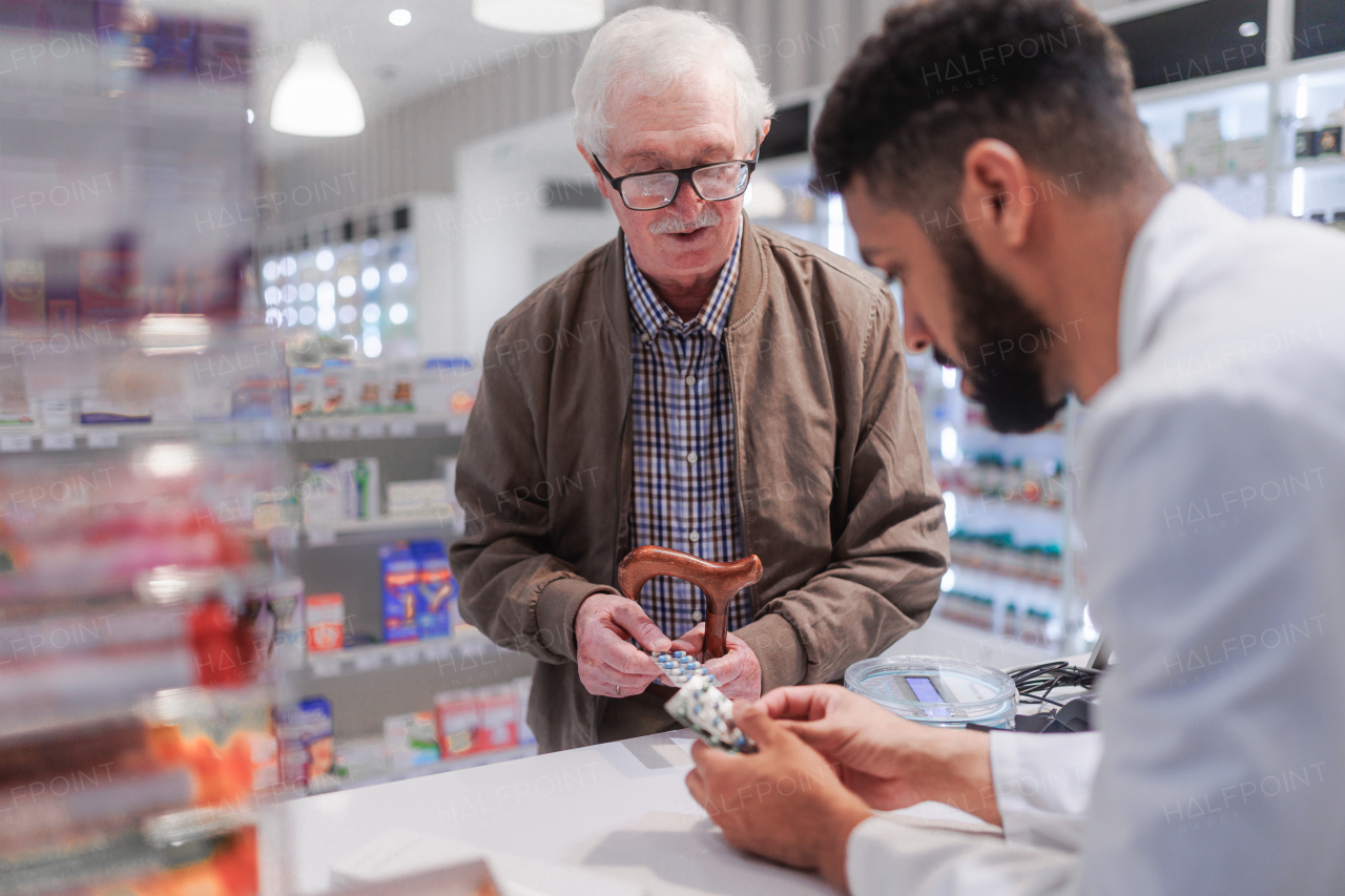 Young pharmacist explaining to customer how to dosing a medication.