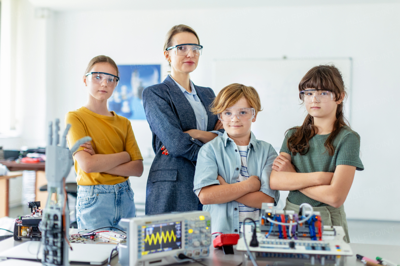 Children learning robotics in Elementary school. Young students building robot in after school robotics club. Field trip to real robotics laboratory.