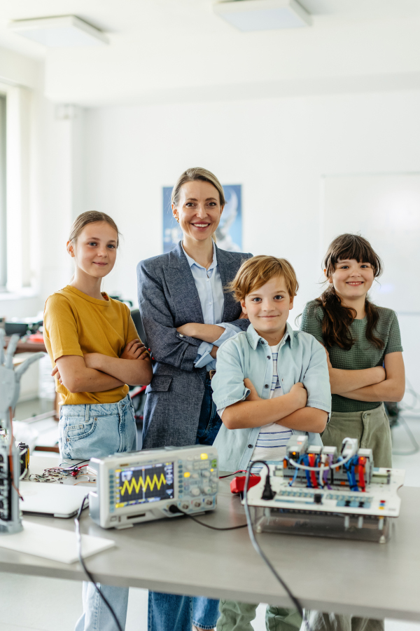 Children learning robotics in Elementary school. Young students building robot in after school robotics club. Field trip to real robotics laboratory.