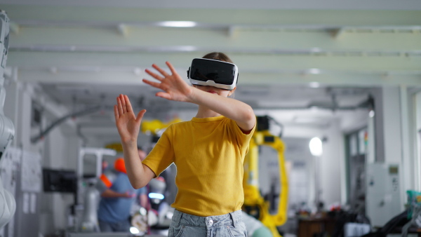 Video of schoolgirl with VR headset on head. Children learning robotics in Elementary school, using modern technology, virtual reality. Girls in science.