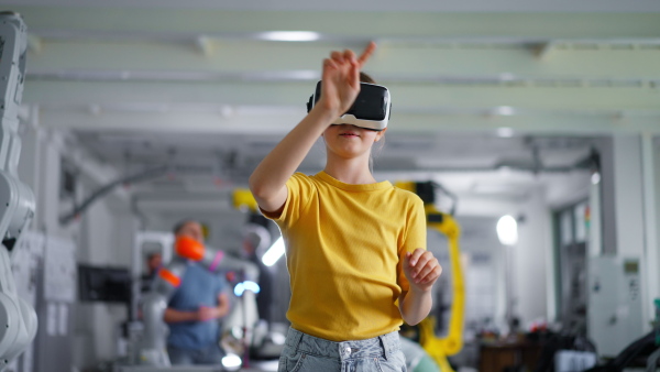 Video of schoolgirl with VR headset on head. Children learning robotics in Elementary school, using modern technology, virtual reality. Girls in science.