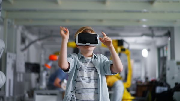 Video of schoolboy with VR headset on head. Children learning robotics in Elementary school, using modern technology, virtual reality. Girls in science.