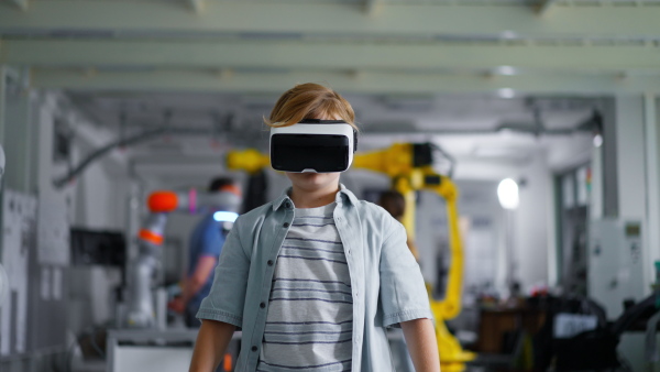 Video of schoolboy with VR headset on head. Children learning robotics in Elementary school, using modern technology, virtual reality. Girls in science.