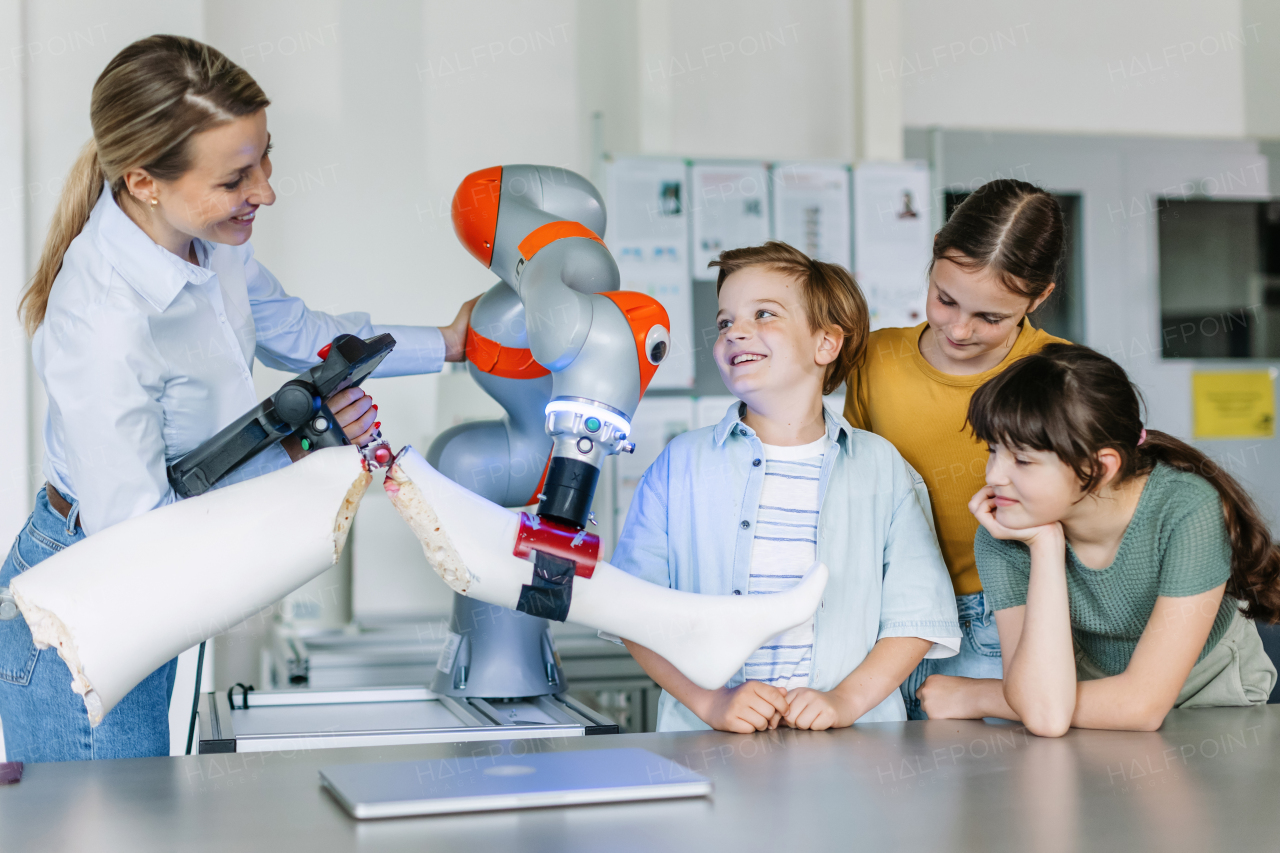 Children learning robotics in Elementary school. Young students going on a field trip to real robotics laboratory.