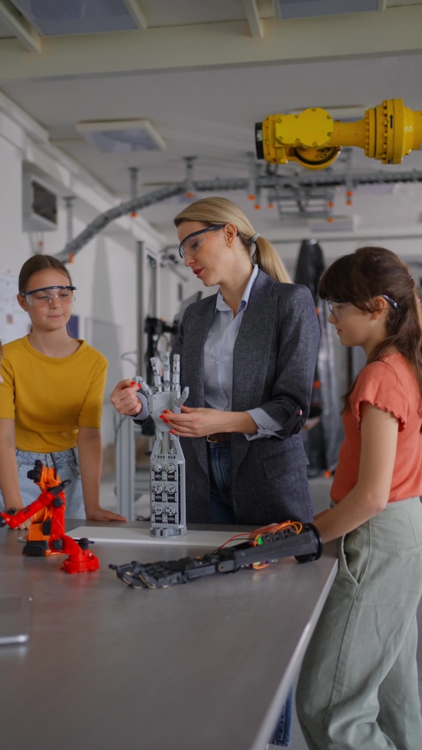 Children learning robotics in Elementary school. Young students building robot in after school robotics club. Field trip to real robotics laboratory.