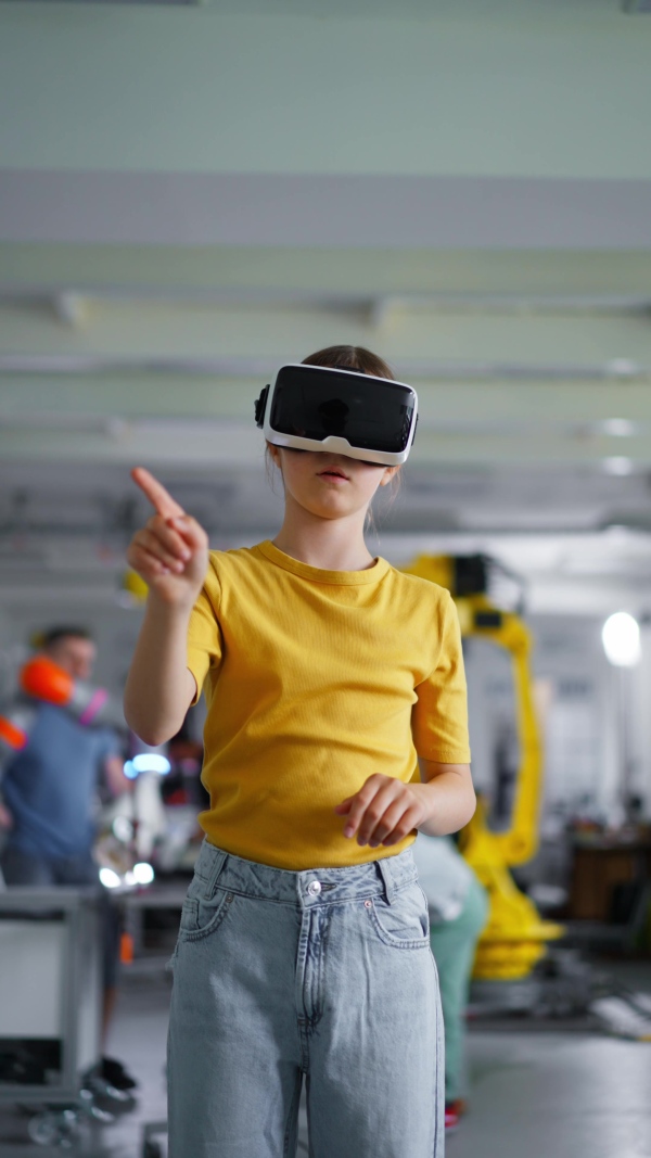 Video of schoolgirl with VR headset on head. Children learning robotics in Elementary school, using modern technology, virtual reality. Girls in science.