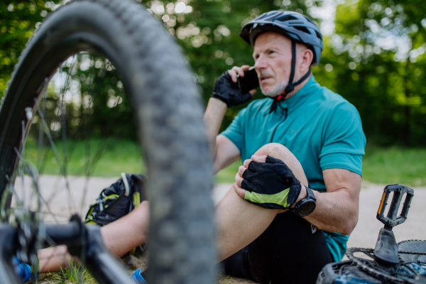 An active senior man calling for help after his bicycle accident.