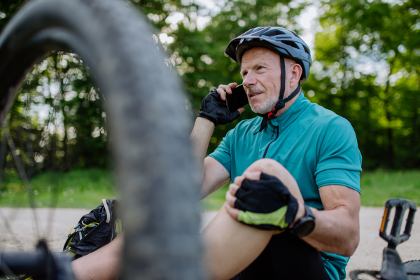 An active senior man calling for help after his bicycle accident.