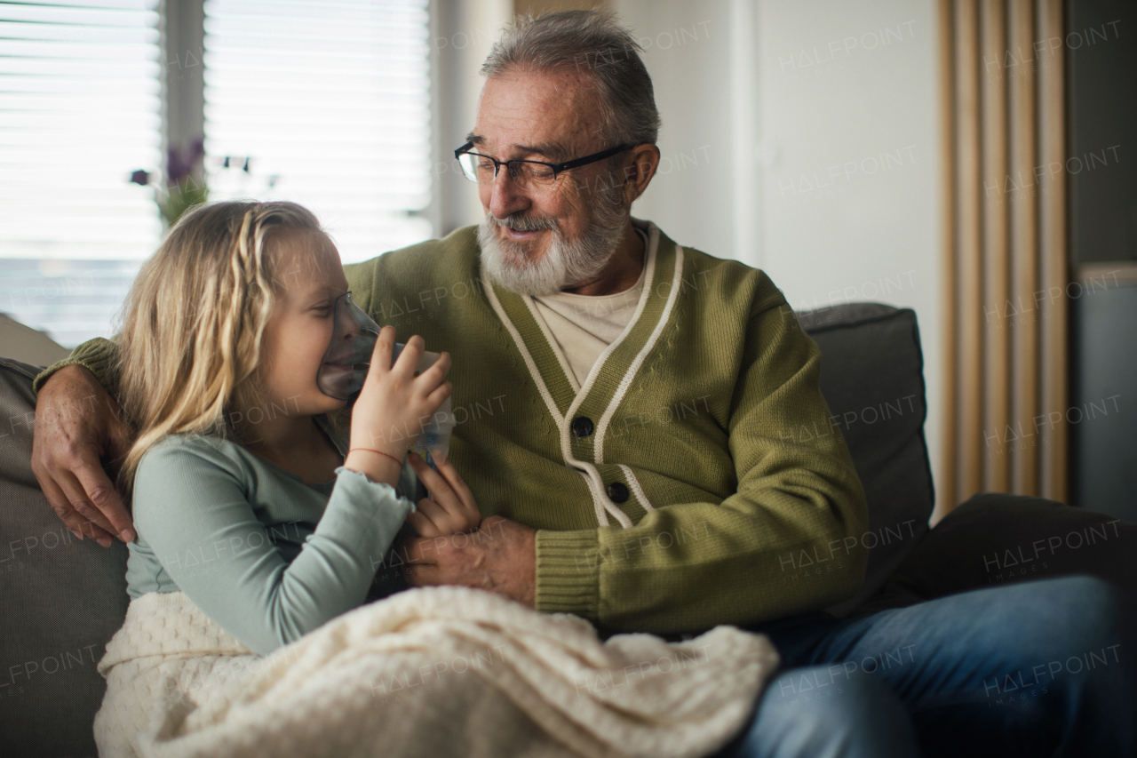 Senior man taking care of sick granddaughter.